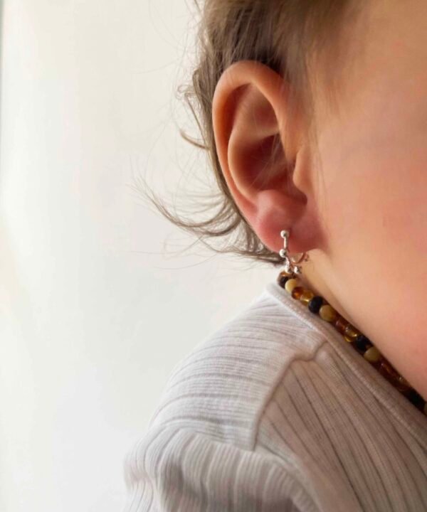 baby girl with little hoop earrings